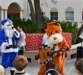 Blue Palm Beach Police santa clause and reindeer playing a guitar 